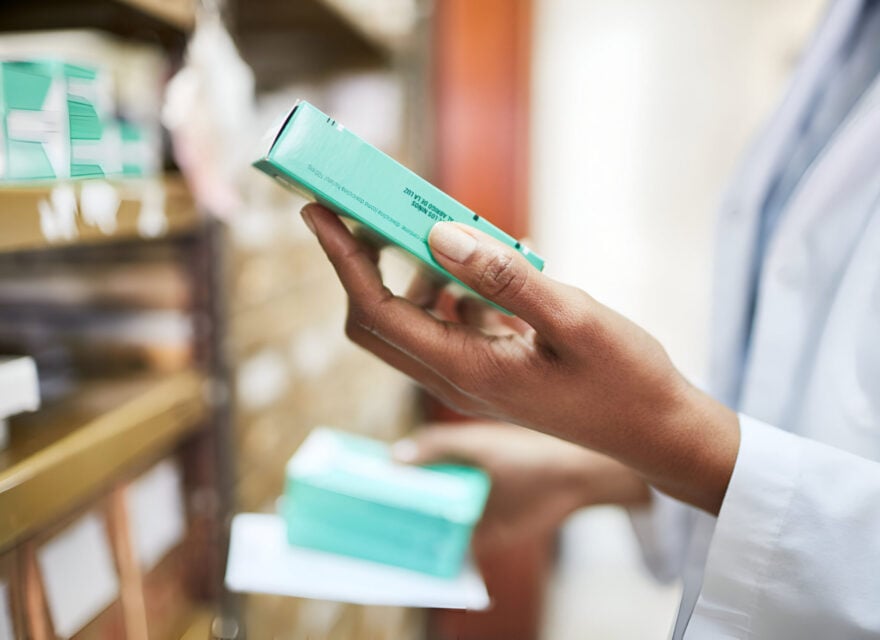 Chemist searching the medicines at storage shelf